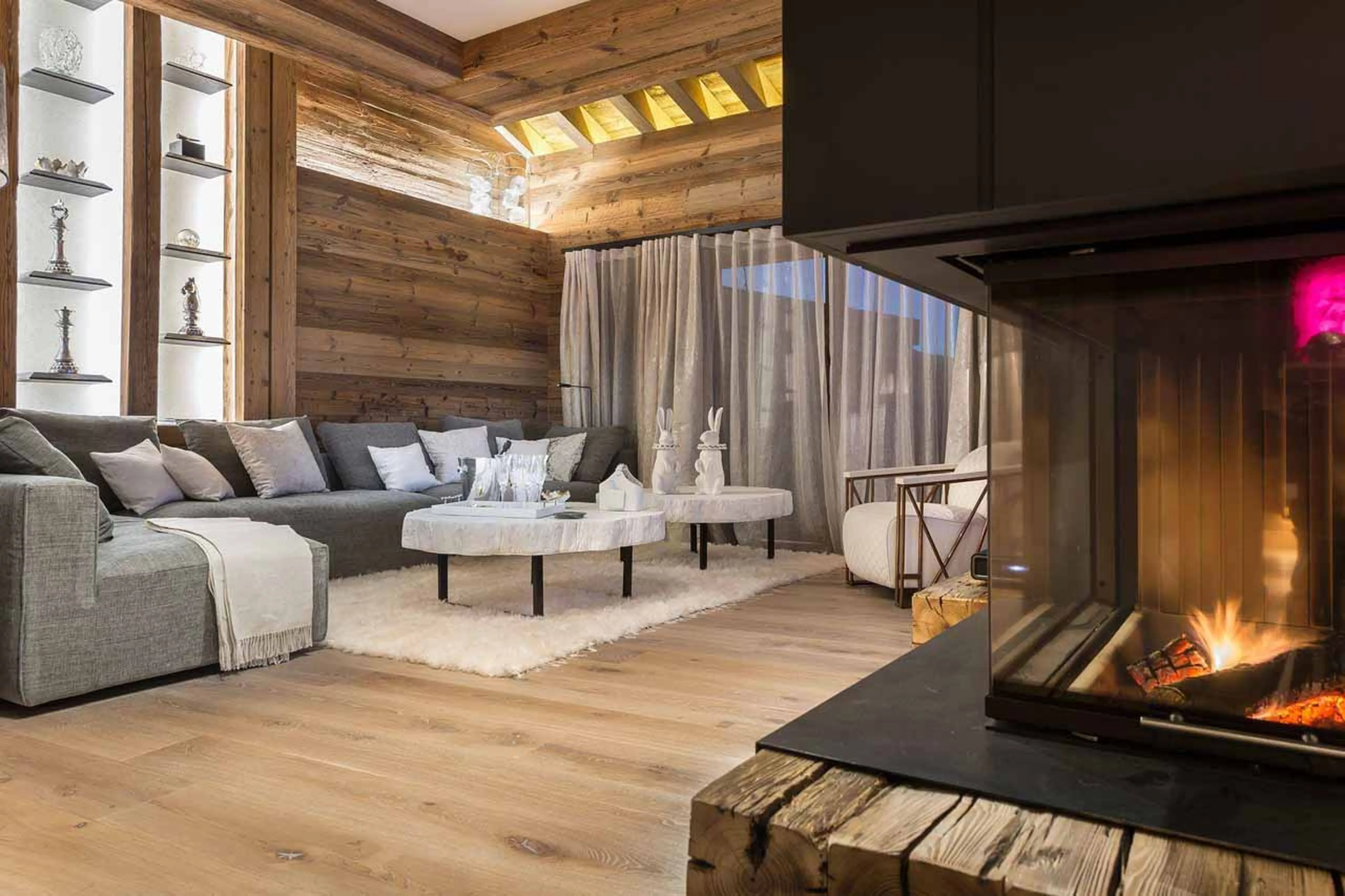 Living room with fireplace at White Chalet in Courchevel Le Praz