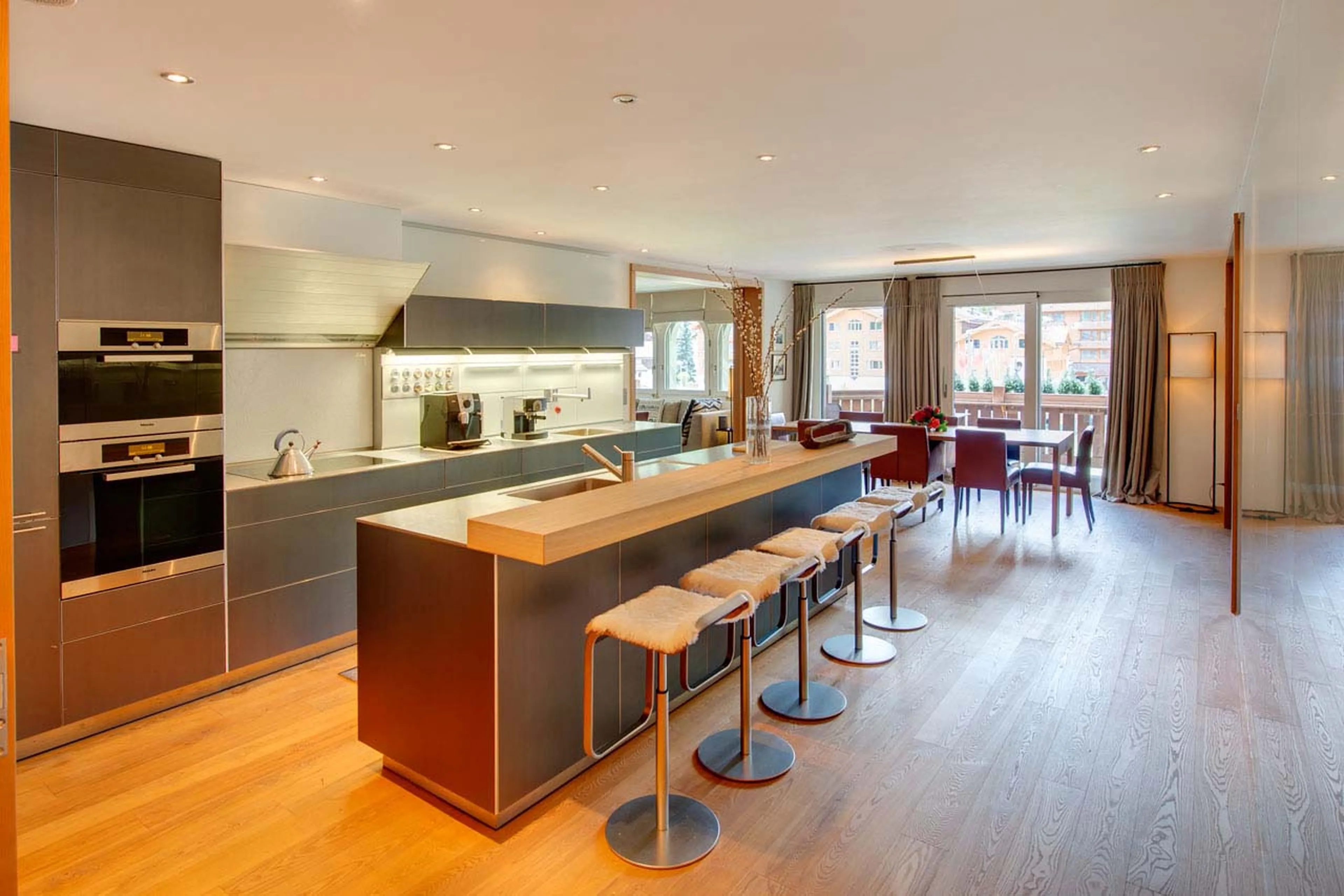 Modern kitchen with breakfast bar at Whymper Residence in Zermatt